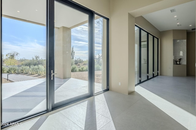 doorway to outside featuring french doors and a wall of windows