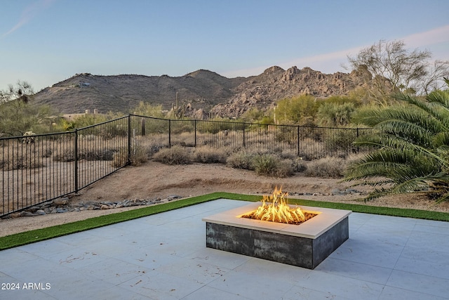 view of patio with a mountain view and a fire pit