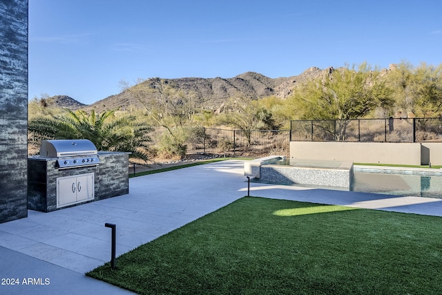 view of yard featuring a fenced in pool, area for grilling, and a mountain view