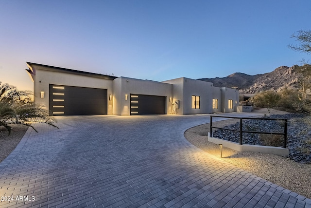 view of front of property with a mountain view and a garage