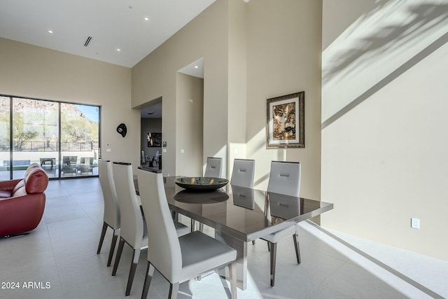 dining space featuring a high ceiling