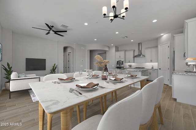 dining room featuring ceiling fan with notable chandelier