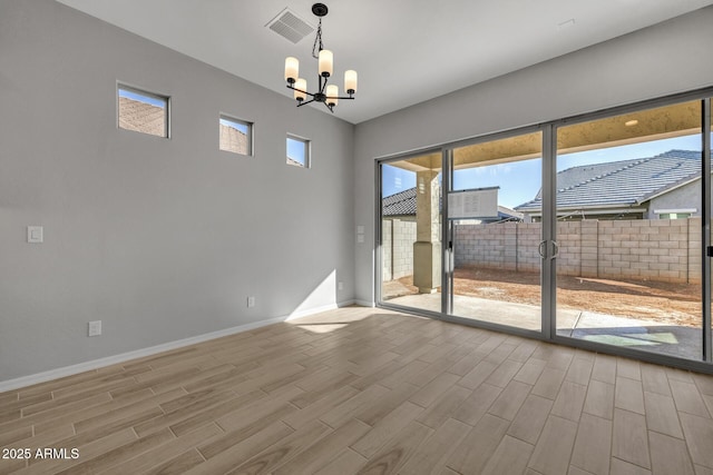 empty room featuring an inviting chandelier