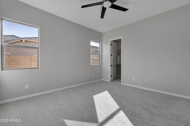 carpeted spare room with ceiling fan