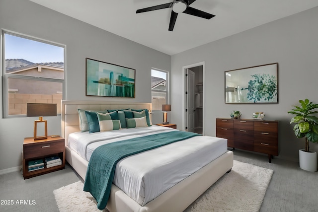 bedroom with ceiling fan and light carpet