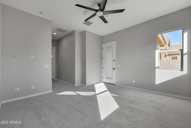 carpeted empty room featuring ceiling fan