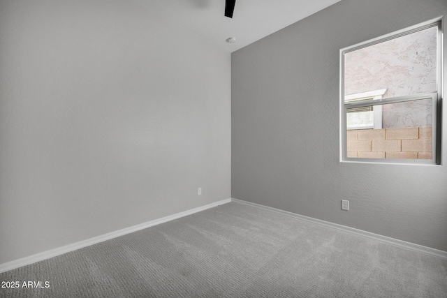 carpeted spare room with lofted ceiling