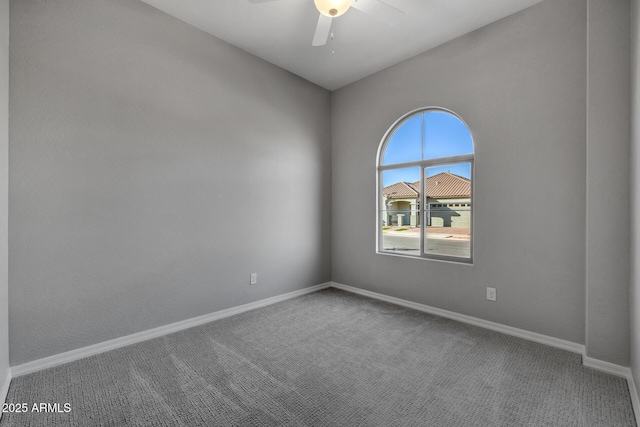 empty room with ceiling fan and carpet