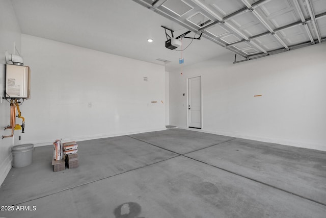 garage with a garage door opener and tankless water heater