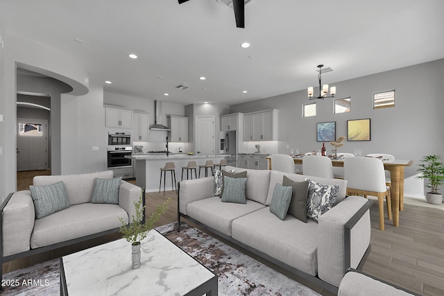 living room featuring a chandelier and light hardwood / wood-style floors