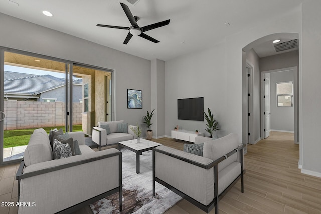 living room featuring ceiling fan and light wood-type flooring