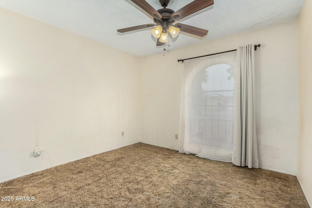 spare room featuring carpet and ceiling fan