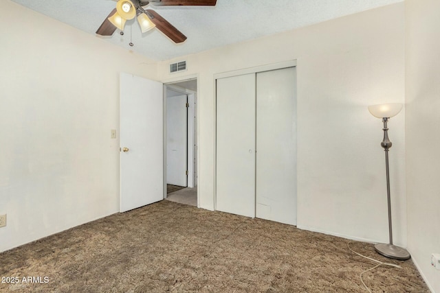 unfurnished bedroom with ceiling fan, a closet, and carpet flooring