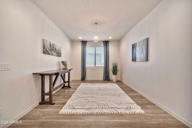 foyer featuring recessed lighting, wood finished floors, and baseboards