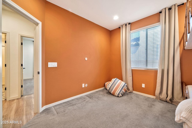 carpeted spare room with baseboards