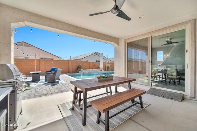 view of patio featuring a ceiling fan, outdoor dining space, and a fenced backyard