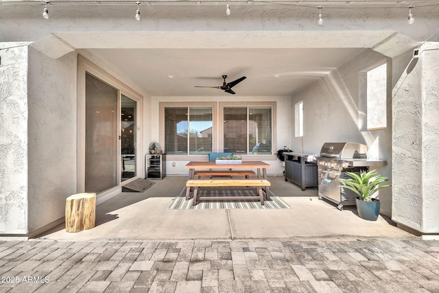 view of patio / terrace with a ceiling fan, outdoor dining space, and area for grilling