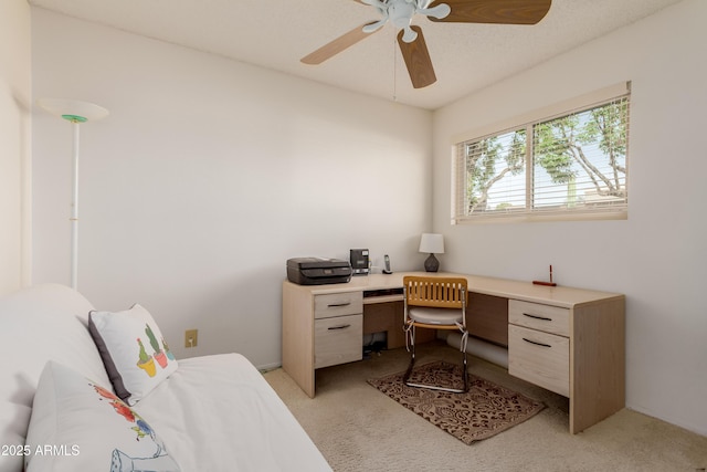 office space with a ceiling fan and light colored carpet