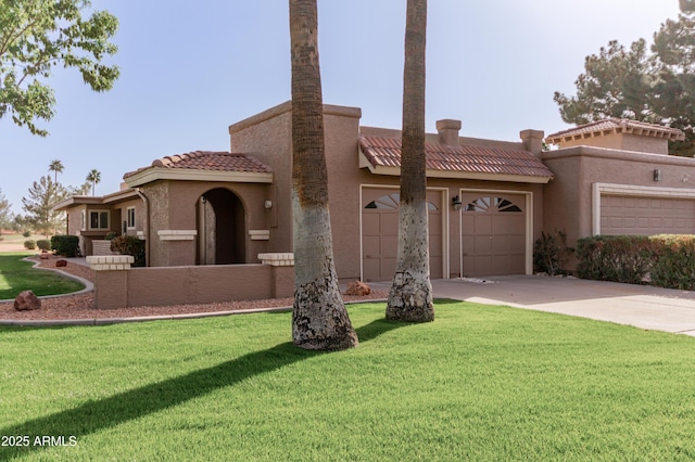 view of front facade featuring a garage, concrete driveway, a tile roof, a front yard, and stucco siding