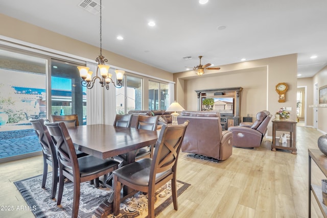 dining room with visible vents, recessed lighting, ceiling fan with notable chandelier, and light wood-style floors