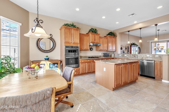 kitchen with visible vents, a notable chandelier, a center island, recessed lighting, and stainless steel appliances