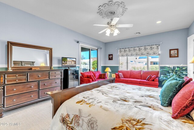 bedroom featuring visible vents, ceiling fan, and carpet flooring