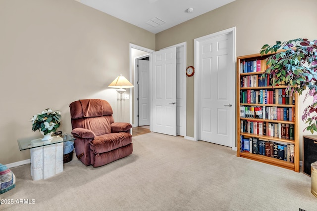 sitting room with carpet and baseboards