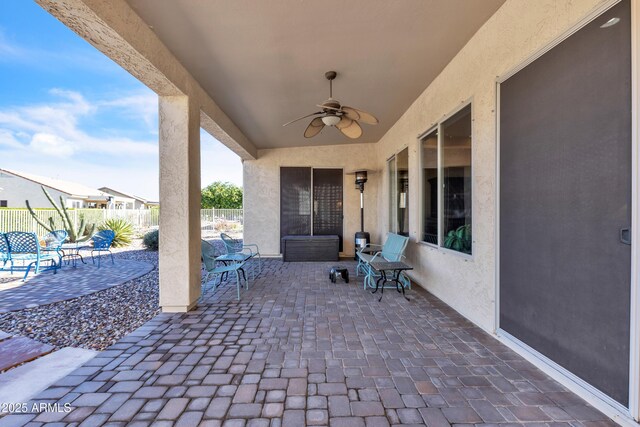 view of patio / terrace featuring fence and ceiling fan