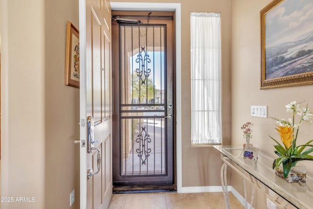 tiled entrance foyer with baseboards