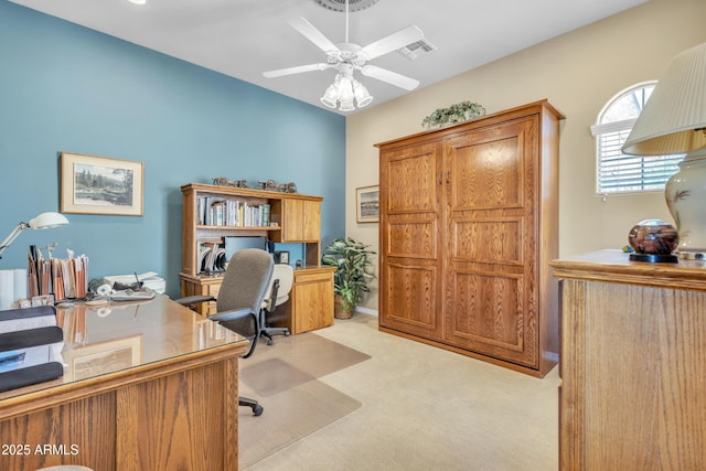 office area featuring visible vents, light colored carpet, and ceiling fan