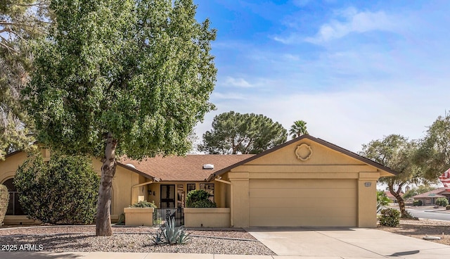 view of front facade with driveway, a garage, and stucco siding