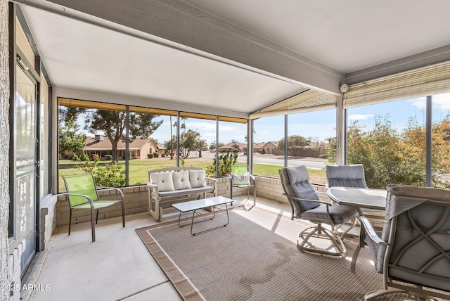 sunroom with vaulted ceiling with beams