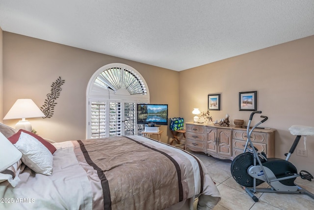 bedroom with a textured ceiling and light tile patterned flooring