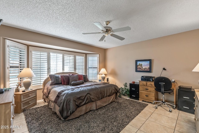 bedroom featuring light tile patterned floors, a textured ceiling, and a ceiling fan