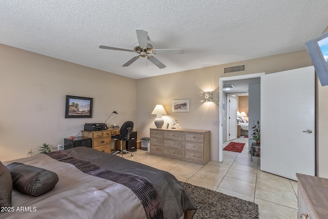 bedroom with light tile patterned floors, ceiling fan, a textured ceiling, and visible vents