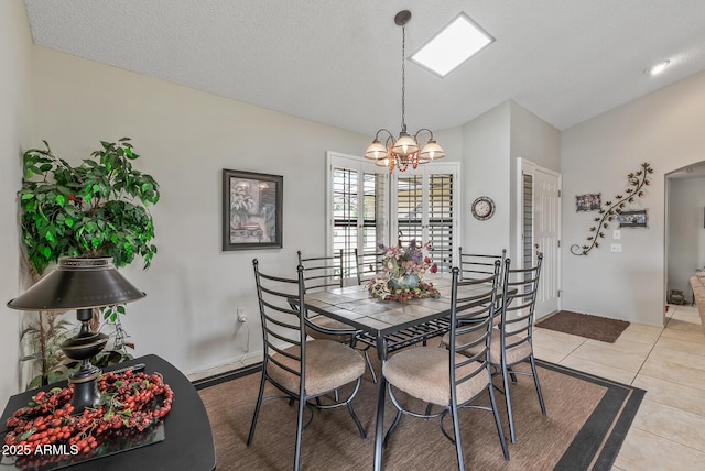 dining room featuring light tile patterned floors, a textured ceiling, vaulted ceiling, and a notable chandelier