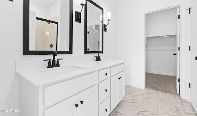 bathroom with vanity and a shower with door