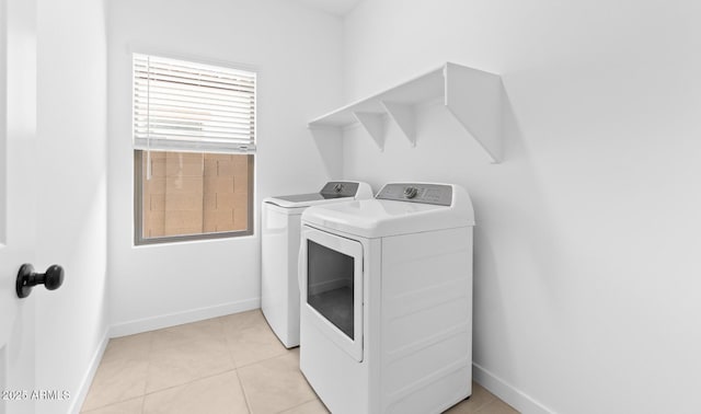 washroom featuring light tile patterned flooring and separate washer and dryer