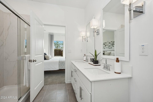 bathroom with tile patterned floors, vanity, and an enclosed shower