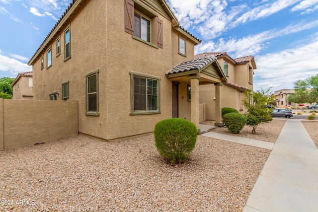 915 E Agua Fria Ln, Avondale, AZ 85323 - view of home's exterior featuring fence, stucco siding, and a tiled roof