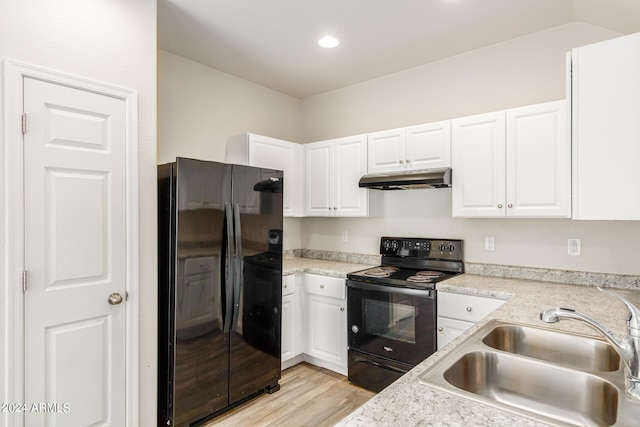 kitchen featuring light wood-type flooring, black appliances, white cabinets, and sink