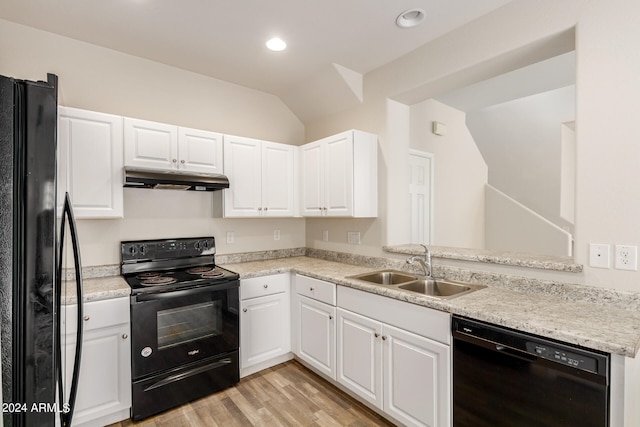 kitchen featuring white cabinetry, light hardwood / wood-style flooring, black appliances, sink, and vaulted ceiling