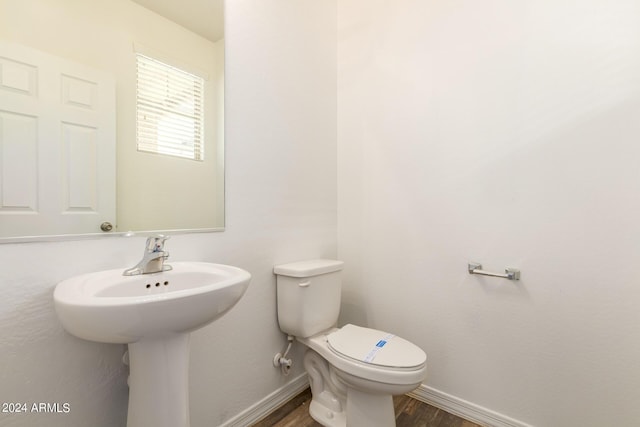 915 E Agua Fria Ln, Avondale, AZ 85323 - half bath with toilet, baseboards, and wood finished floors