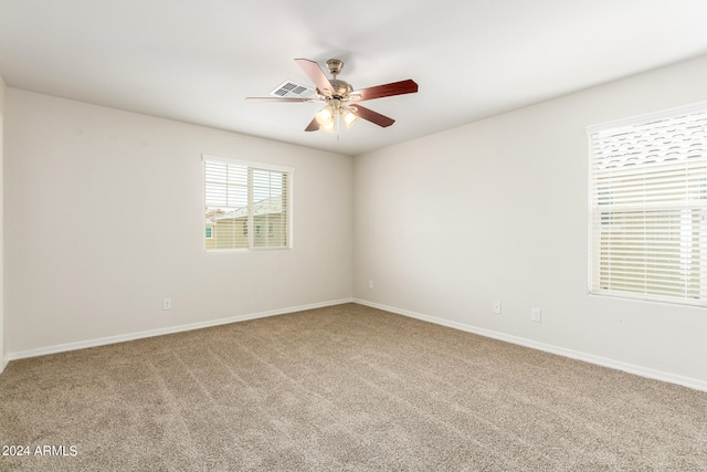 carpeted spare room with ceiling fan