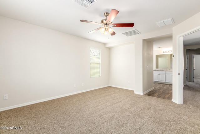 carpeted spare room with ceiling fan