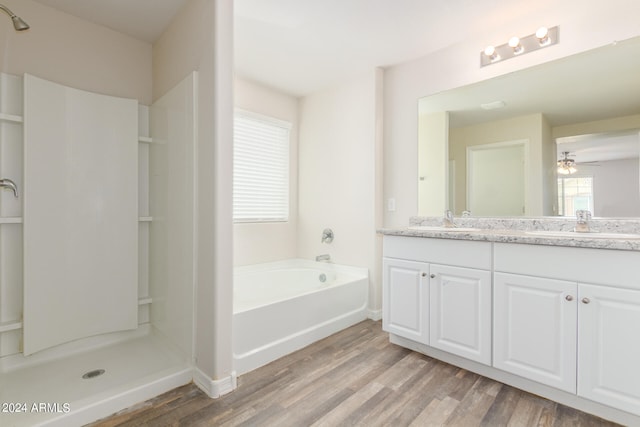 bathroom featuring vanity, ceiling fan, hardwood / wood-style floors, and shower with separate bathtub