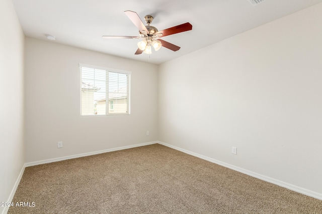 carpeted empty room featuring ceiling fan