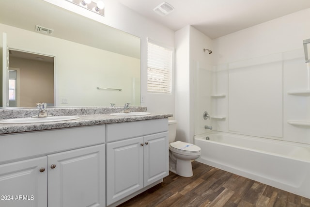 full bathroom featuring wood-type flooring, toilet, shower / bath combination, and vanity