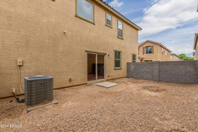 rear view of house featuring cooling unit