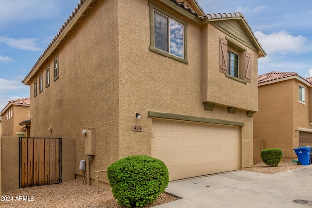 915 E Agua Fria Ln, Avondale, AZ 85323 - view of property exterior with stucco siding, a tile roof, and concrete driveway